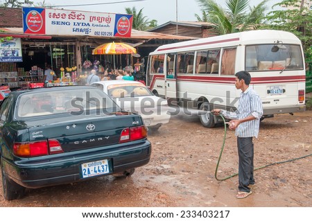 Poi Pet,Cambodia - October 01,2009 : The Canbodian worker washing cleaning tourist car at the road side shop in  Poi Pet of Cambodia.