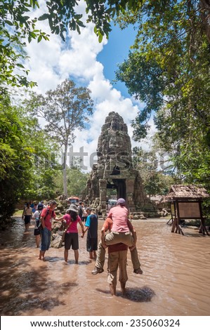 siem Reap,Cambodia - October 02,2009 :  Tourists visiting Ta Prohm temple on  flood situation in Siem Reap, Cambodia. Ta Prohm is a jungle temple  in Angkor.