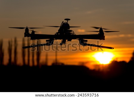 Hexacopter drone flying in the sunset