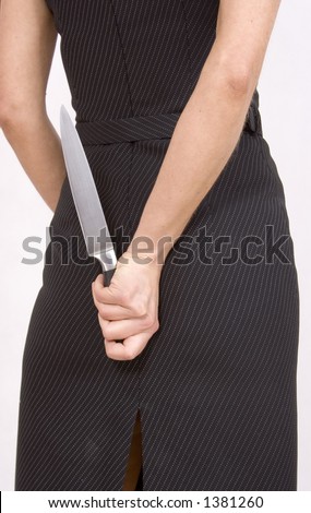 Businesswoman hide a kitchen knife behind her back