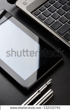 Business still life: laptop, tablet, fountain pen.