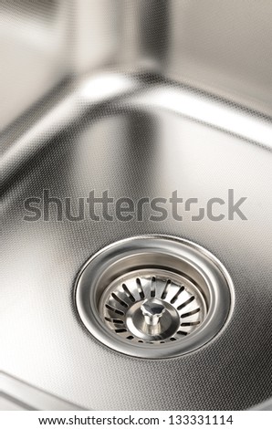 Stainless steel sink with drain. Closeup.
