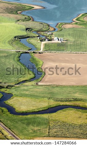 An aerial view of farmland and a small reservoir to store irrigation water
