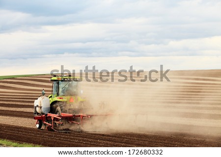 Rexburg, Idaho, USA.  Jun. 16, 2011  Tractors and other farm machinery plowing farm fields.