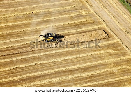 Shelly, Idaho, USA Aug. 16, 2014 An aerial view of farm machinery in the field harvesting wheat