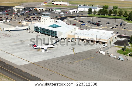 Idaho Falls, Idaho, USA Aug. 16, 2014 An aerial view of an airport terminal in a mid sized American city.  It depicts long and short term parking, car rental, taxiway, jet ways, and terminal building.