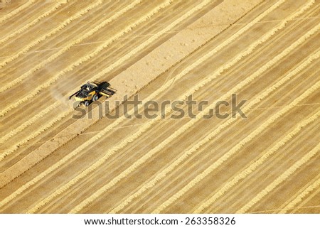 Shelly, Idaho, USA Aug 16, 2014 An aerial view of farm machinery in the fertile farm fields of Idaho, harvesting wheat