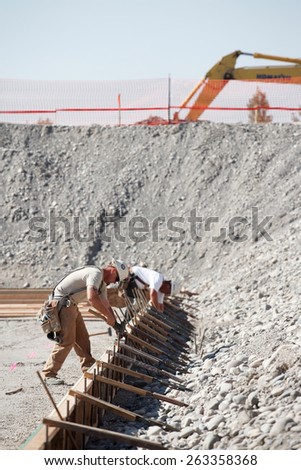 Shelly, Idaho, USA Jul 31, 2008 Two men setting up concrete forms at a construction site.