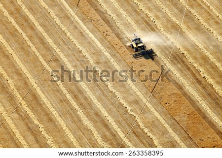 Shelly, Idaho, USA Aug 16, 2014 An aerial view of farm machinery in the fertile farm fields of Idaho, harvesting wheat