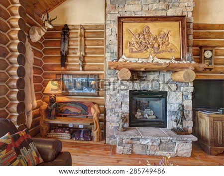 Driggs, Idaho, USA Nov, 12, 2014 The great room in a rustic log cabin, with with a stone fireplace, and rustic western decor.
