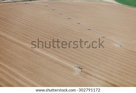 American Falls, Idaho, USA Apr. 21, 2015 An aerial view of farm machinery planting potatoes in the fertile farm fields of Idaho.