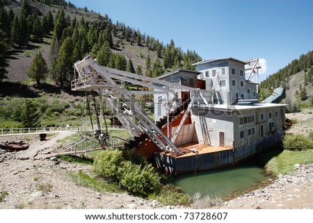 An abandoned decaying gold dredge located on the Yankee Fork of the Salmon river in Custer Idaho, USA