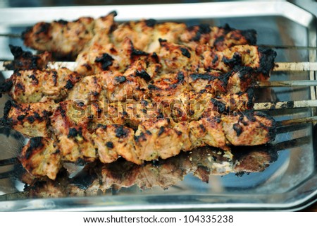 fresh portions of shish kebab on metal plate