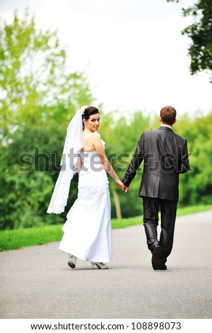 bride and groom walking along the street