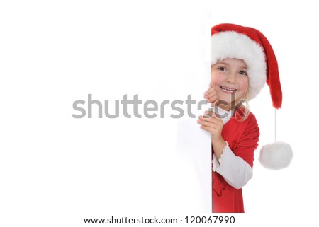 little girl in red santa hat  peeking from  billboard.