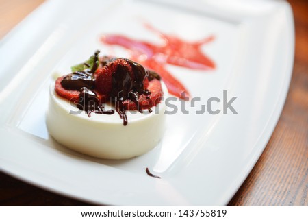 dessert of whipped cream with strawberries and chocolate