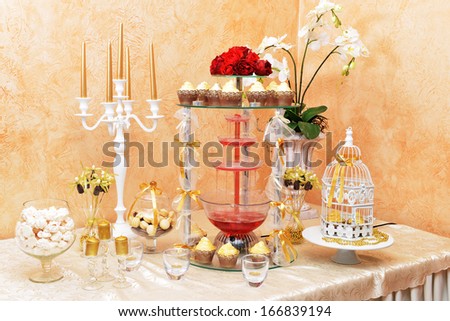 decoration of wedding table. Romantic candle holders and cupcakes