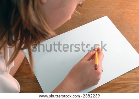 young woman with pencil writing on paper