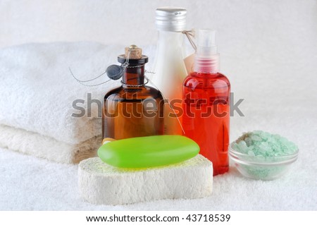 different cosmetics for body and  towel on  white
