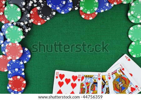 different color chips for gamblings and playing cards on green