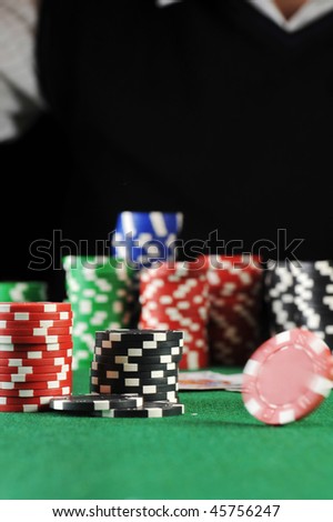 different color chips for gambling on green background.