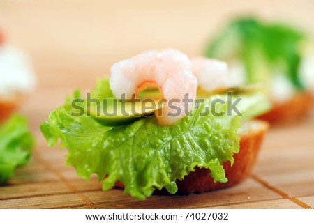 Sandwich garnish with shrimps, avokado and lettuce on  bamboo napkin, snack