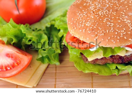 hamburger with cutlet and vegetables on bamboo napkin