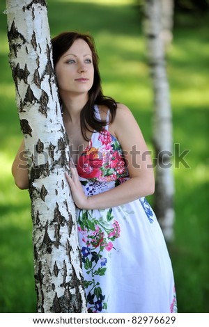 beautiful  future mom standing near  tree.  summer\'s day.