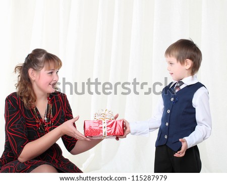 Mother gives present to her little son