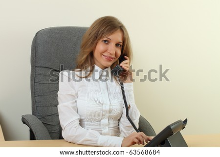 Business woman calling with a phone in office