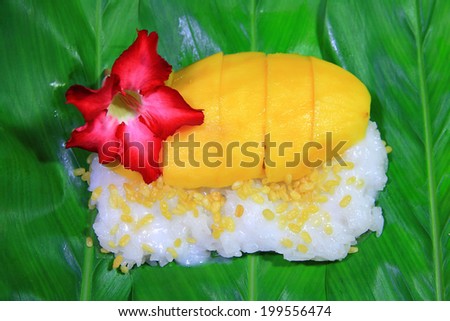 Sweet mango with sticky rice and topping with coconut milk and mung beans.