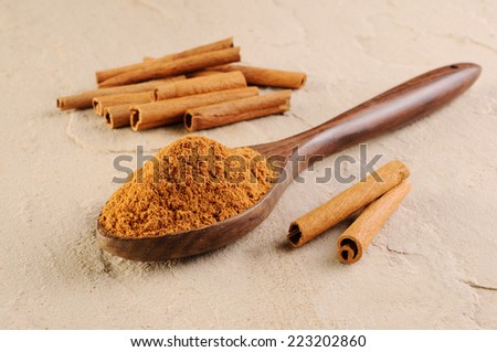 Cinnamon sticks and meal,Cinnamon sticks and cinnamon powder in wooden scoop