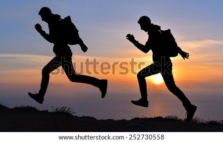 Running jumping man above sunset and mountain. Sport sky sun nature