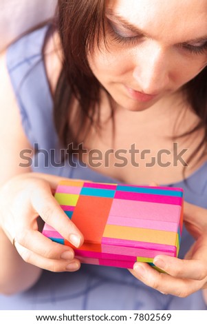 Beautiful young woman with gift box