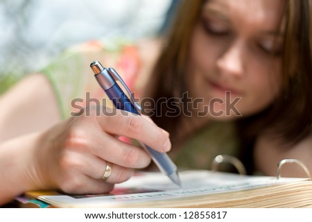 Girl writing in exercise book