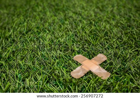 Adhesive plasters sticked to green grass close up