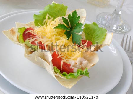 Chicken with tomatoes and cheese in a basket made of dough \