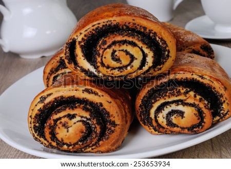 Freshly baked rolls with poppy seeds on a plate
