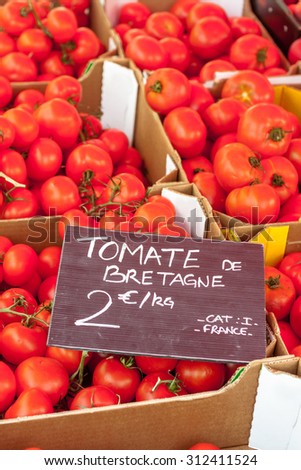 Bright red ripe tomatoes grown in Brittany on sale at a market