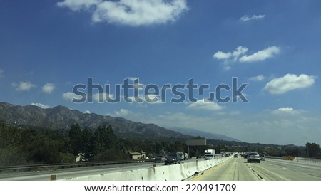 Los Angeles, CA - September 19, 2014: Highway traffic in Sunland-Tujunga near San Gabriel Mountains along highway I-210, Los Angeles suburb, Southern California