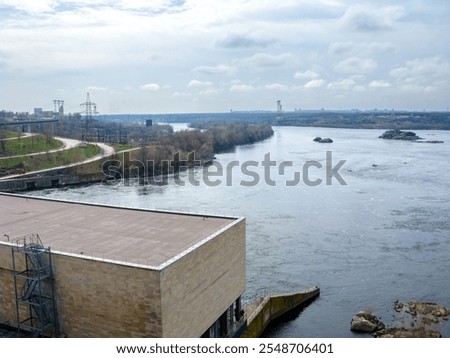 Similar – Foto Bild Gegenlichtlandschaftsbild mit Brücke, Fluss und Strommast