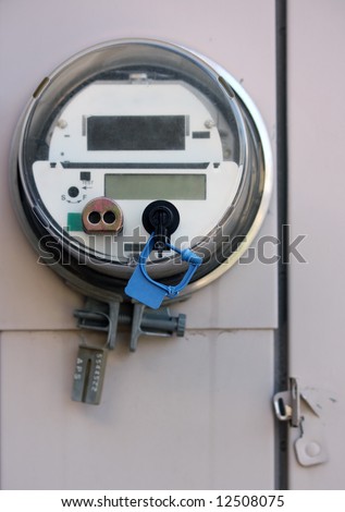 Electric meter on outside wall of house