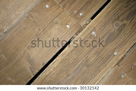 Segment of Old Wooden Walkway with Nail Heads and Gap