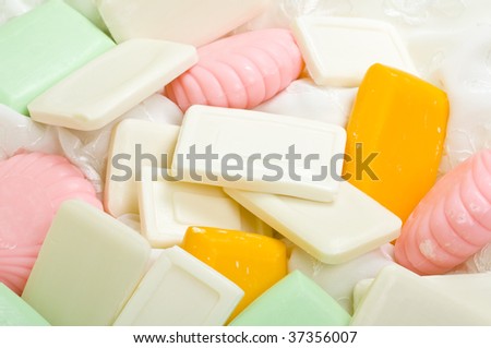 Background made of pink, yellow and green herbal soap bars