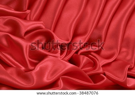 Angle artistic folds of red satin background; close up