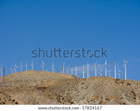 Blue Sky Smoke Free behind Electric Wind Mill Turbines