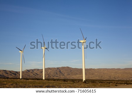 Renewable electricity generating wind mill turbine towers in desert mountain corridor, Palm Springs, CA
