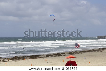 Speeding over ocean waves with wind kite on surf board