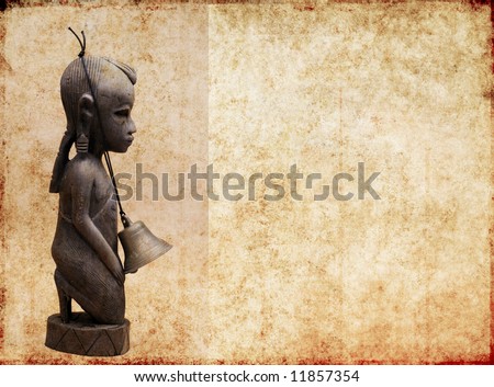 lovely brown background image with interesting texture, profile of a west african wooden statue and plenty of space for text