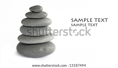 balancing stones / pebbles against white background